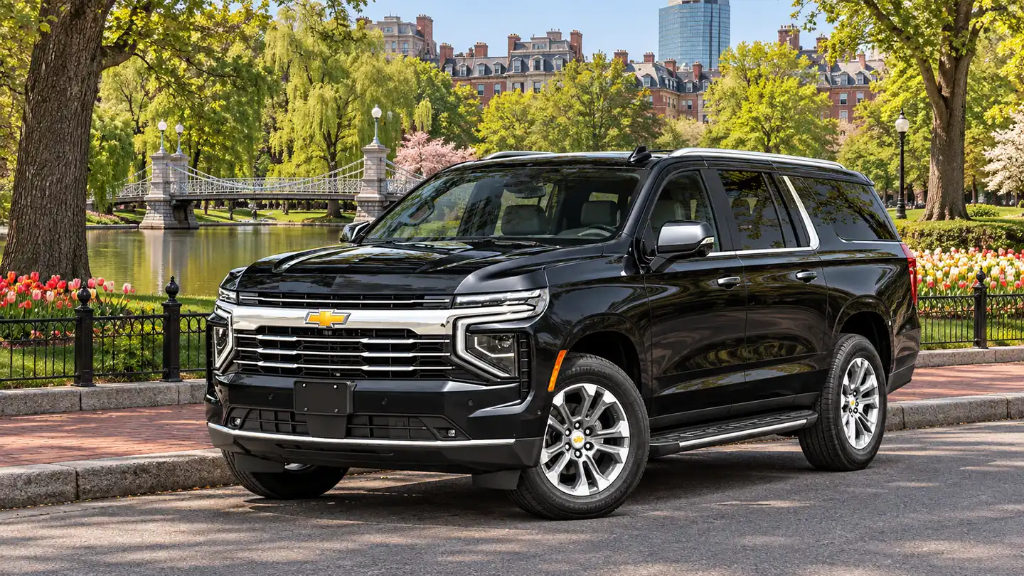 Black Chevrolet Suburban luxury SUV beside the Boston Public Garden